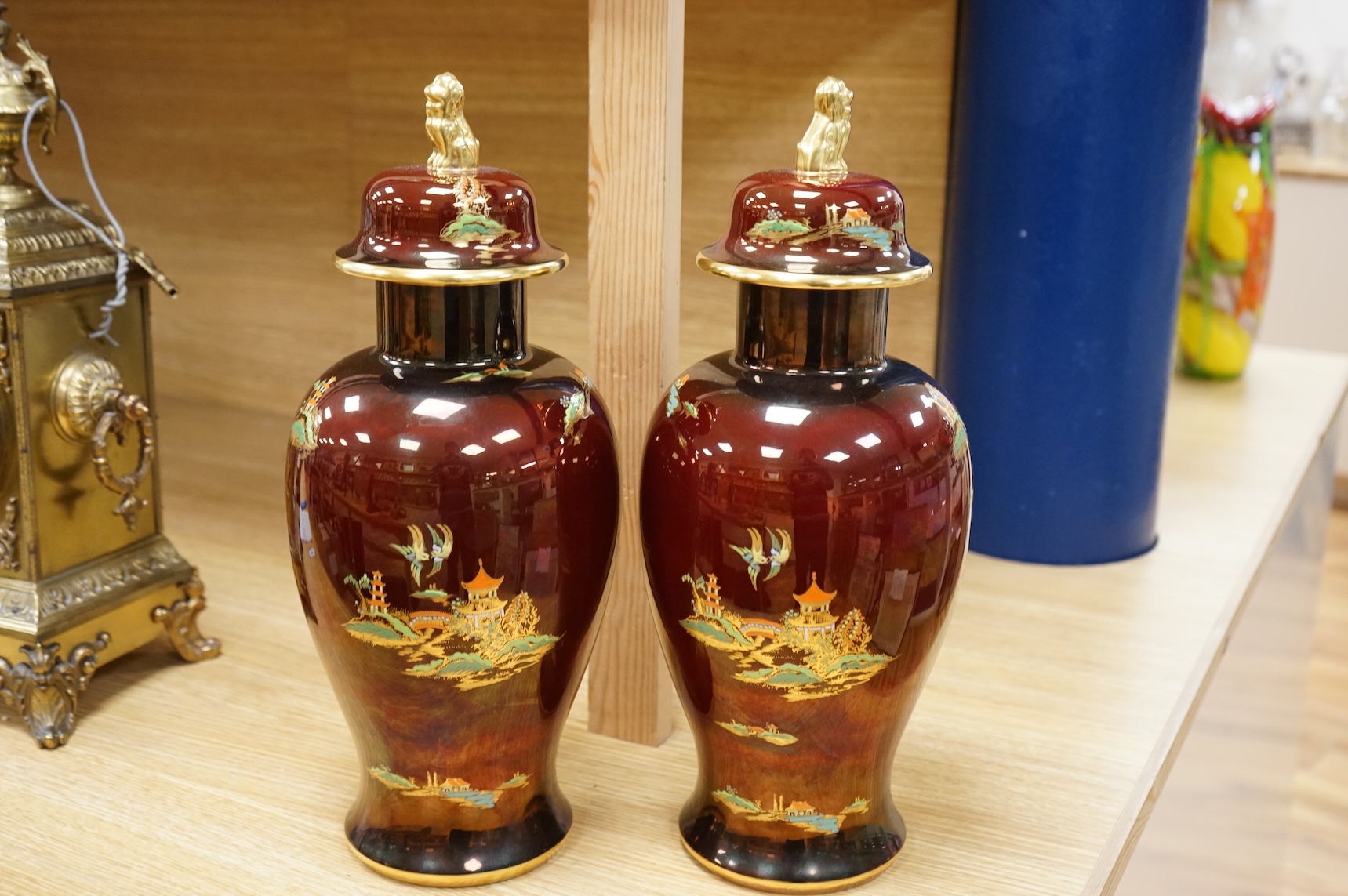 A pair of Carlton Ware Rouge Royale lustre vases and covers with chinoiserie decoration, 38cm high